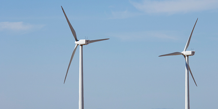 A stock photo of two wind turbines